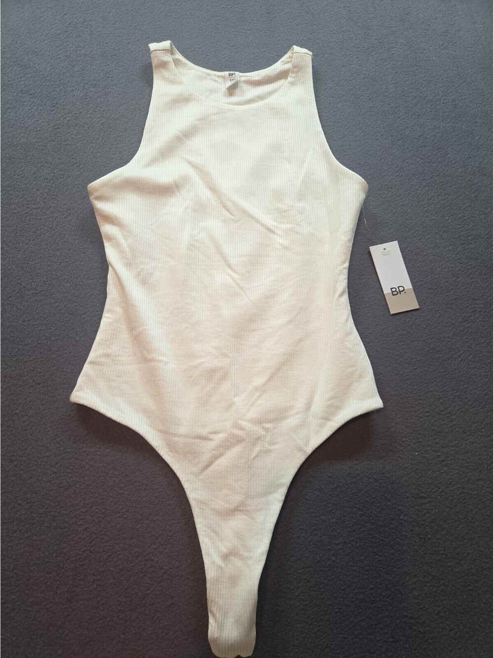 women's whiteribbed bodysuit features a high neck and sleeveless design by BP...